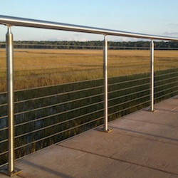 A stainless steel railing with cable strands